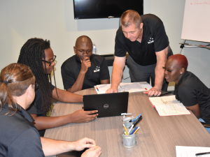 CEO Rodney McLeod (second from right) gives instructions to the MIS team on DNS architecture