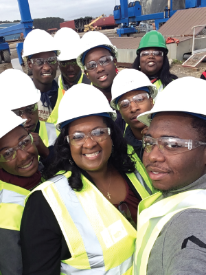 Vanessa Brown, Principal, Baptist Hill Middle/High School, in the middle foreground surrounded by Baptist Hill students visiting the Stevens Towing shipyard